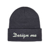 Photo of a dark gray toque with the words "design me" embroidered on it.